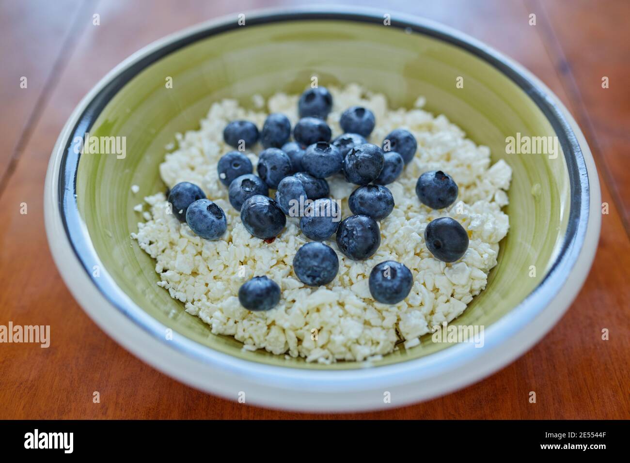 A bowl of cottage cheese with blueberries Stock Photo