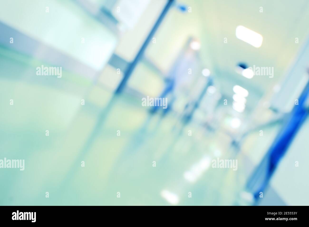 Blurred person in hospital hallway, unfocused background. Stock Photo