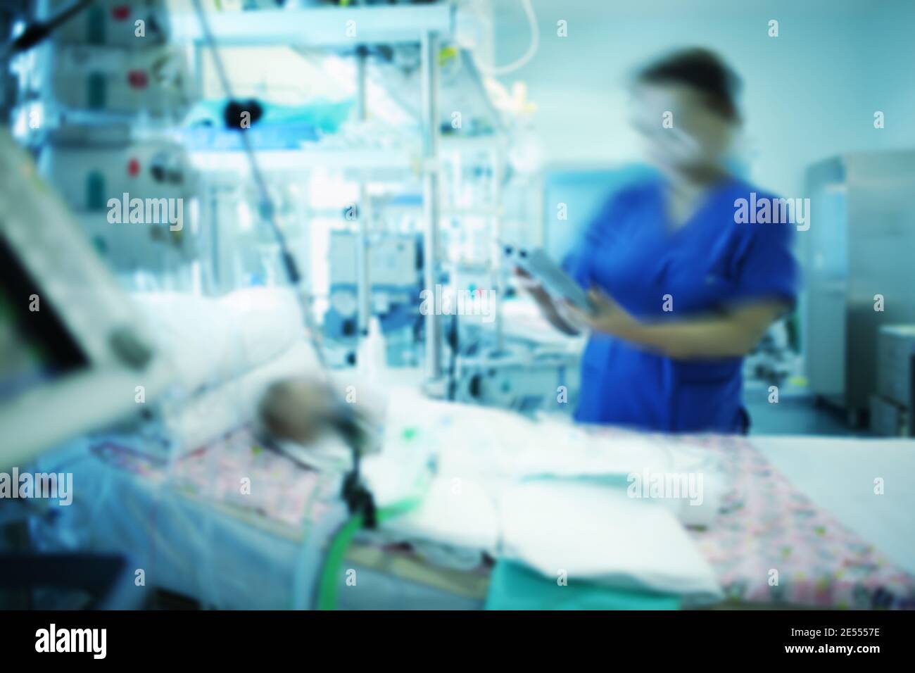 Female doctor working with comatose baby in the intensive care unit. Stock Photo
