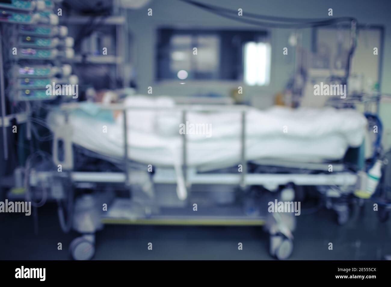 Clinical ward with patient in coma, unfocused background. Stock Photo