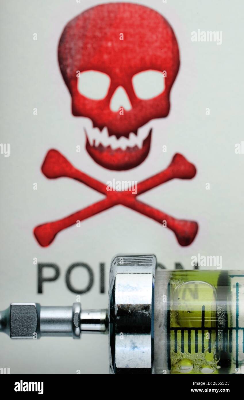 Drug syringe on the background of scull-and-crossbones. Stock Photo