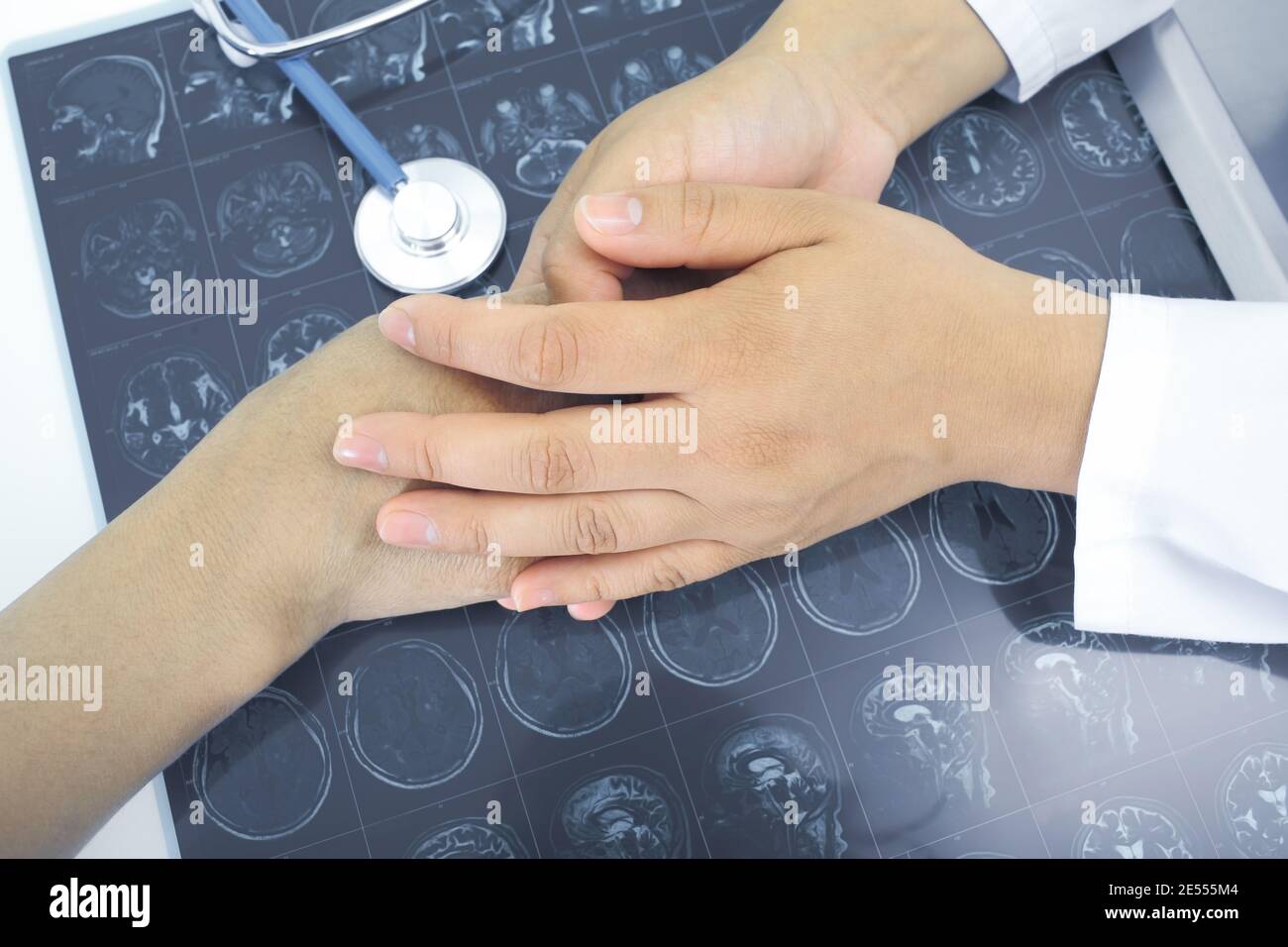 Doctor comforting a terminally ill patient. Stock Photo