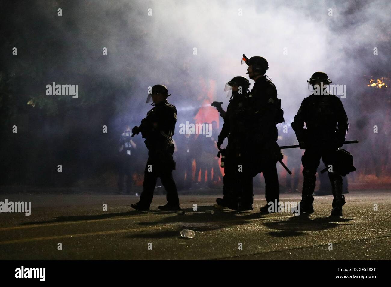 Portland Police officers disperse a crowd of protesters with CS gas on the 100th consecutive night of protests in Portland, Oregon, U.S. September 5, 2020. Picture taken September 5, 2020. REUTERS/Caitlin Ochs Stock Photo