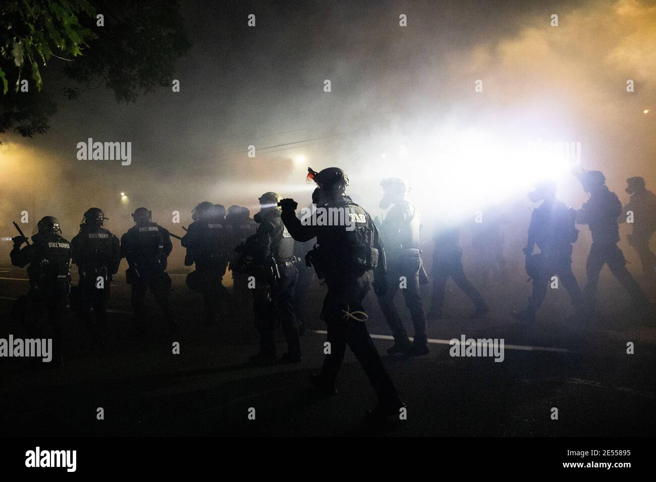 Portland Police officers disperse a crowd of protesters using CS gas and less lethal munitions on the 100th consecutive night of protests in Portland, Oregon, U.S. September 5, 2020. Picture taken September 5, 2020. REUTERS/Caitlin Ochs Stock Photo