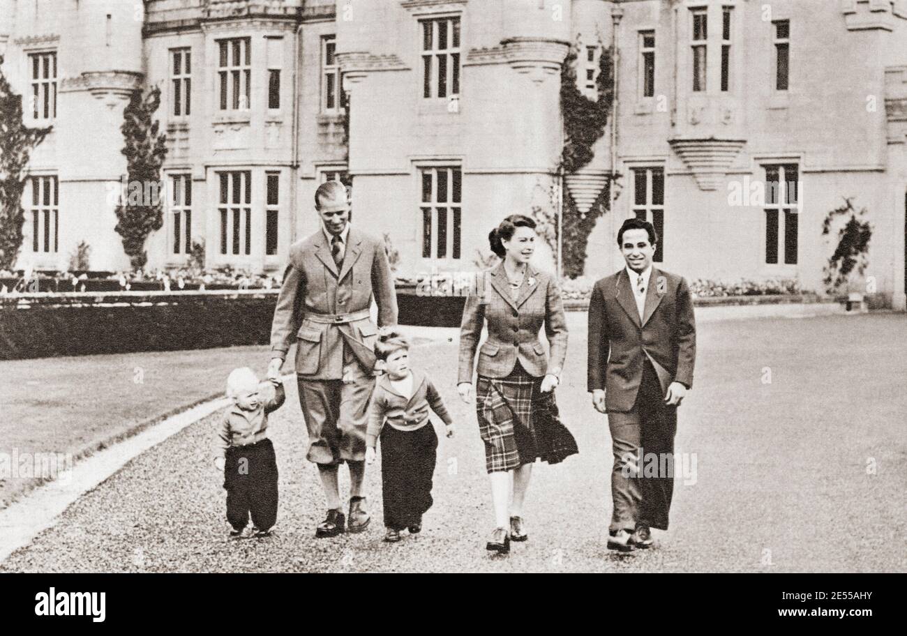 EDITORIAL ONLY Elizabeth II  and The Duke of Edinburgh with Faisal II of Iraq, seen here at Balmoral in 1952.  Elizabeth II, Queen of the United Kingdom,1926 - 2022. Prince Philip, Duke of Edinburgh, born Prince Philip of Greece and Denmark,1921- 2021. Husband of Queen Elizabeth II of the United Kingdom.  Faisal II, 1935 – 1958.  Last King of Iraq.  From The Queen Elizabeth Coronation Book, published 1953. Stock Photo