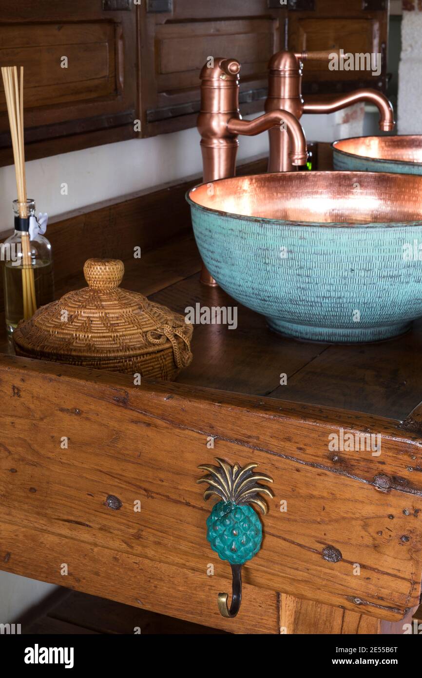 Bathroom details, copper sink and wooden table, hanger Stock Photo