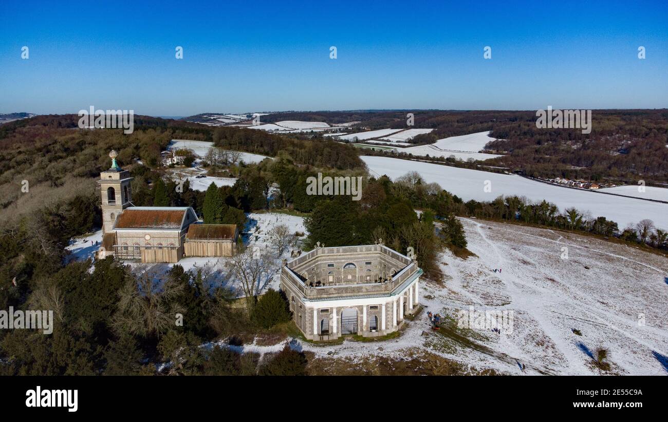 Aerial drone shots of snow covered West Wycombe St Marys Church and the Mausoleum in the winter, Buckinghamshire, England Stock Photo