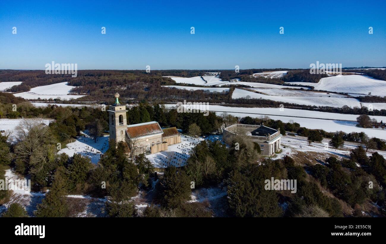 Aerial drone shots of snow covered West Wycombe St Marys Church and the Mausoleum in the winter, Buckinghamshire, England Stock Photo