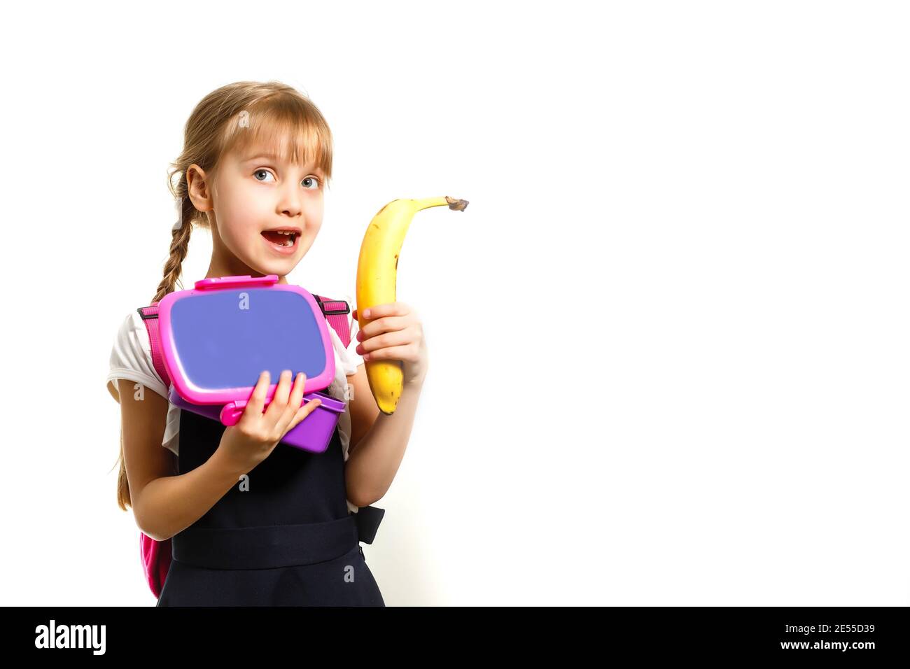 Pupils of primary school with lunch-boxes in hands. Girls with ...