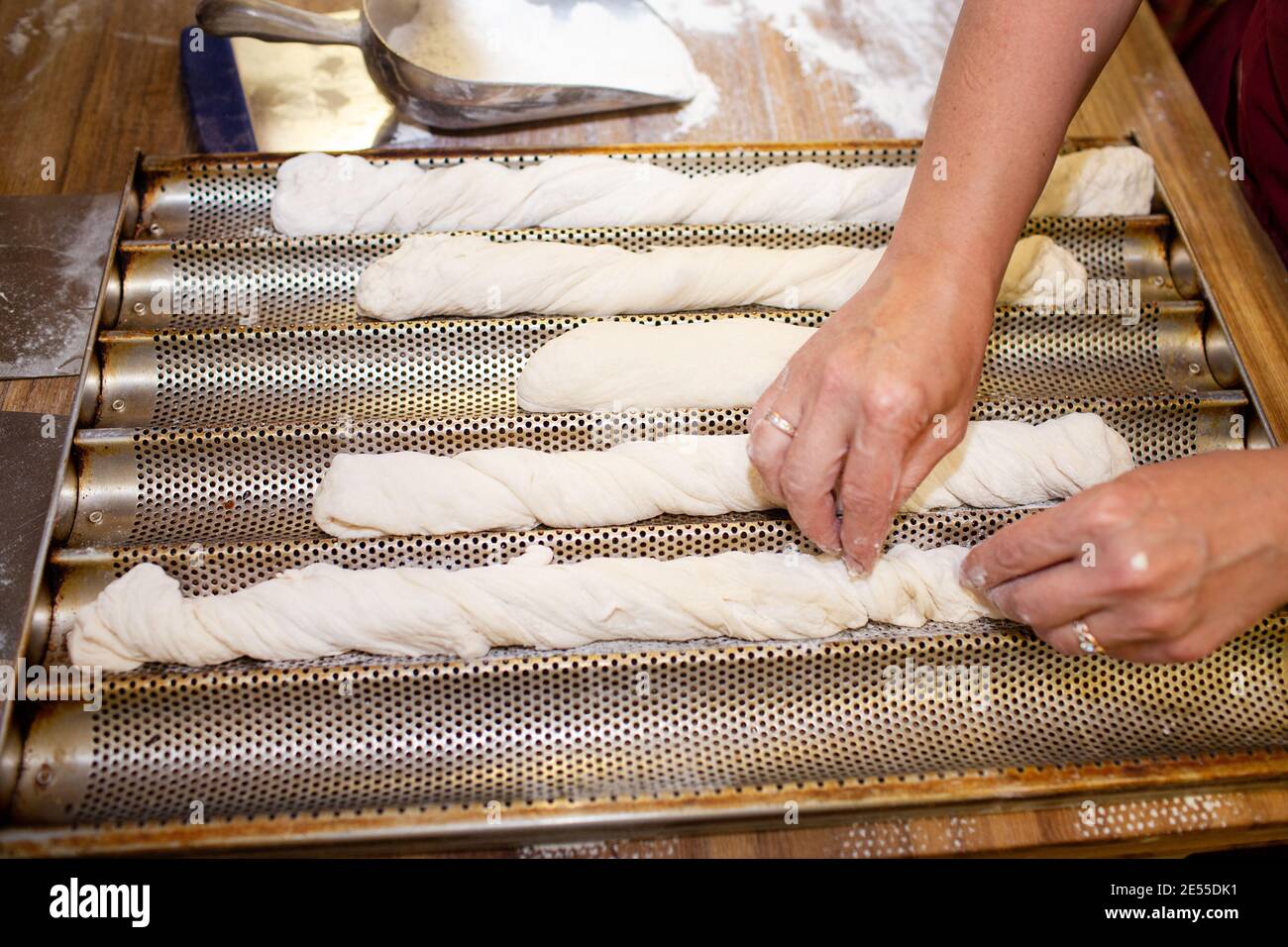 Bread baking process. Woman working with dough. forming a baguette