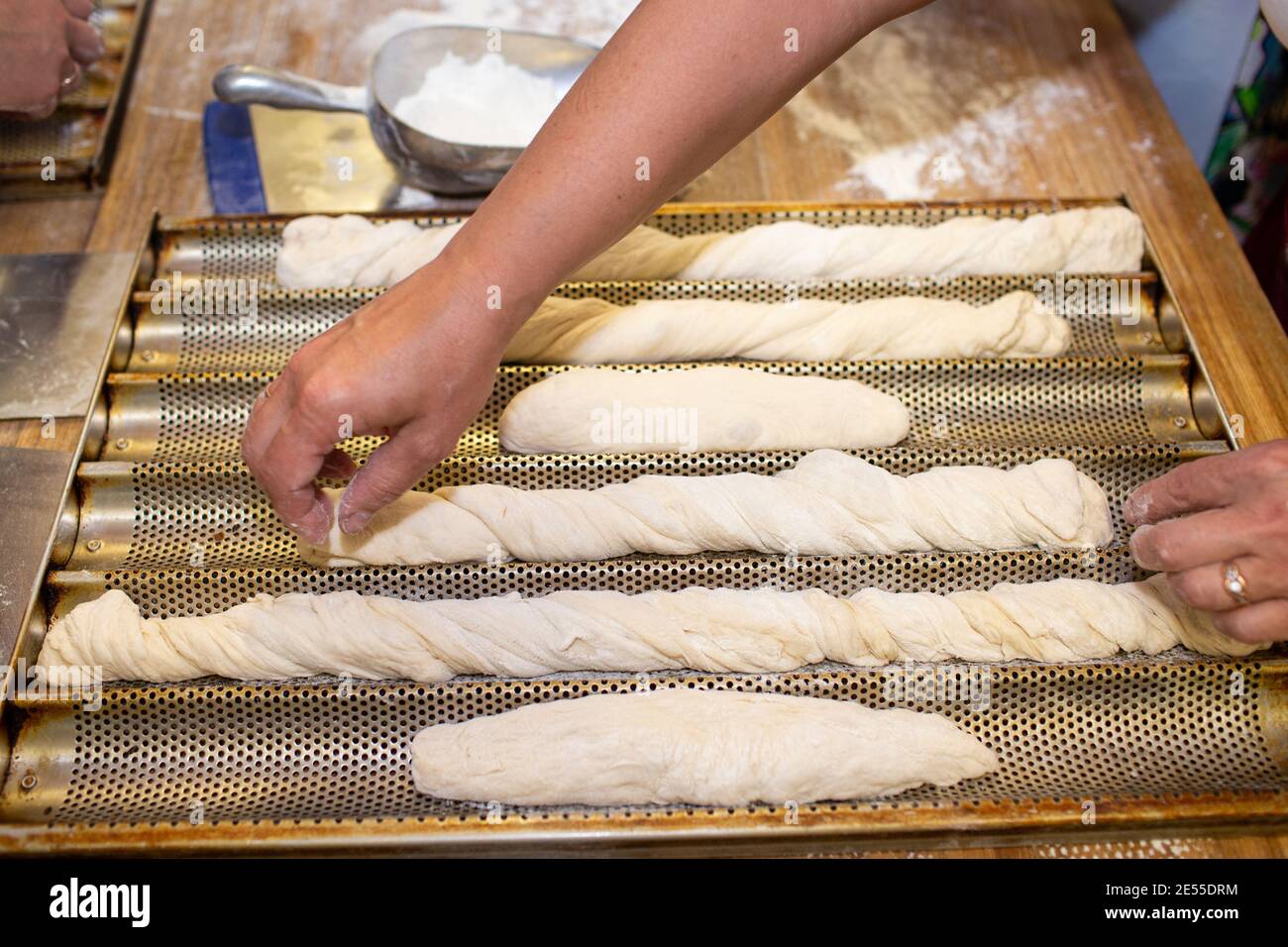 Bread baking process. Woman working with dough. forming a baguette