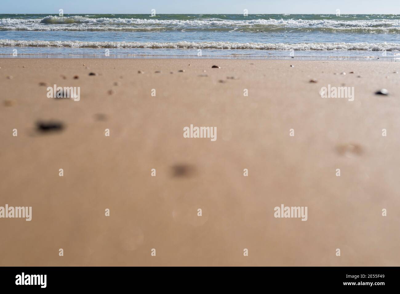 beach sand and waves, background with copy space and selective focus Stock Photo