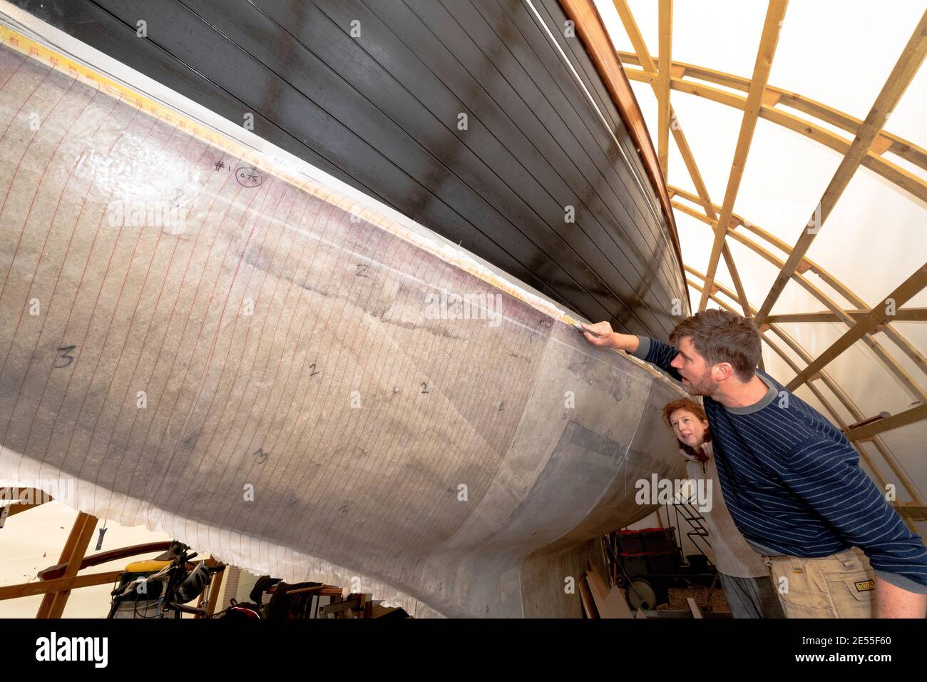 Baba 35  yacht Black Sheep"being in stages of a major refit by Tim Newson owner and shipwright in his purpose -built boat tent at Dell Quay Chichester Stock Photo