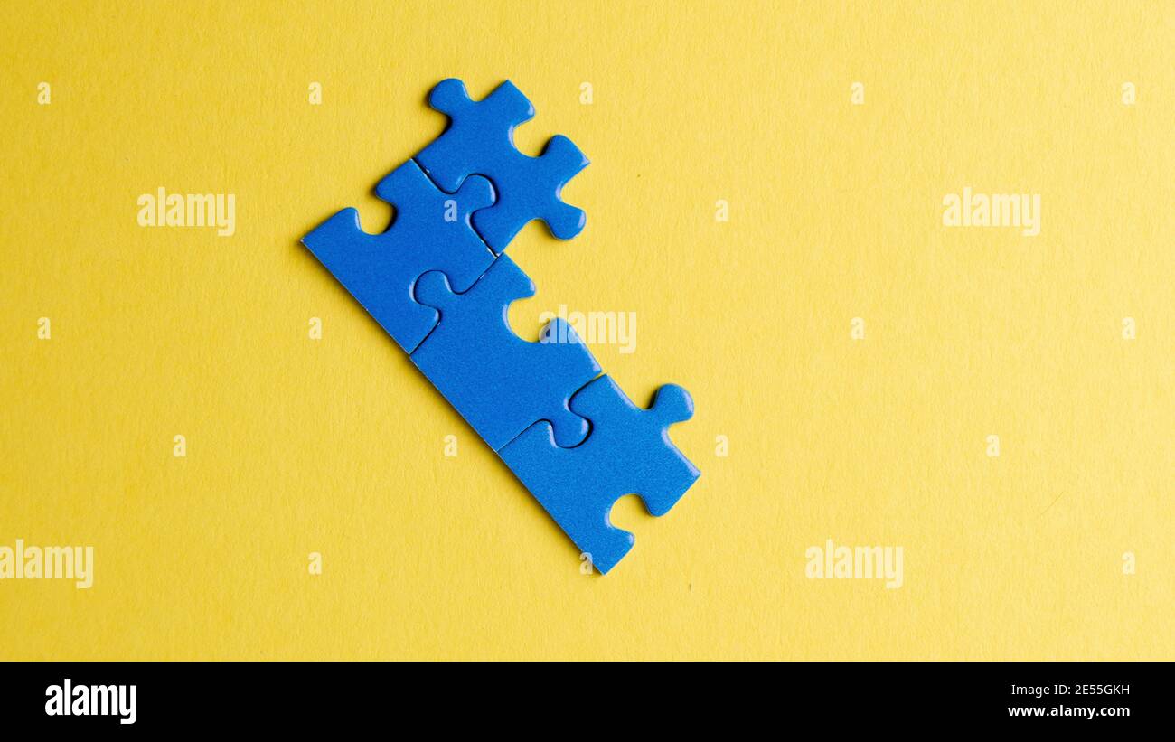 scattered puzzle pieces on colored background Stock Photo