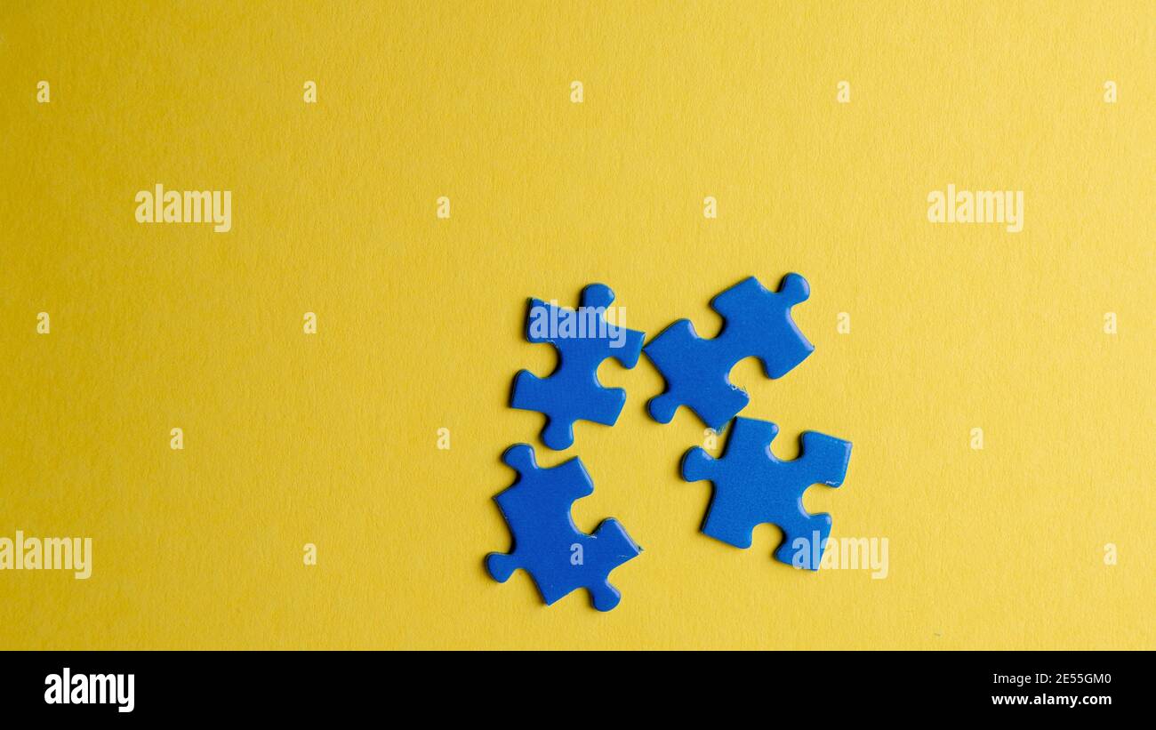 scattered puzzle pieces on colored background Stock Photo
