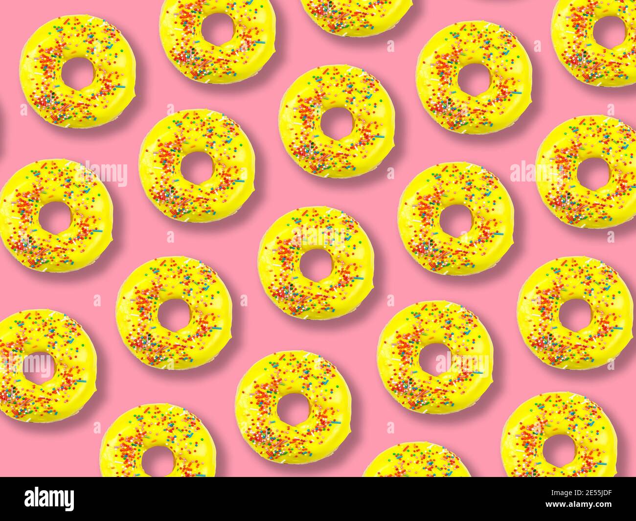 Pattern of yellow donuts on a pink background Stock Photo - Alamy