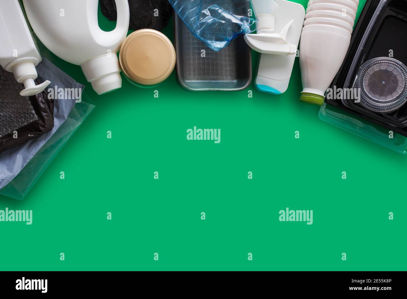 Processing plastic concept. Plastic containers on the green Stock Photo