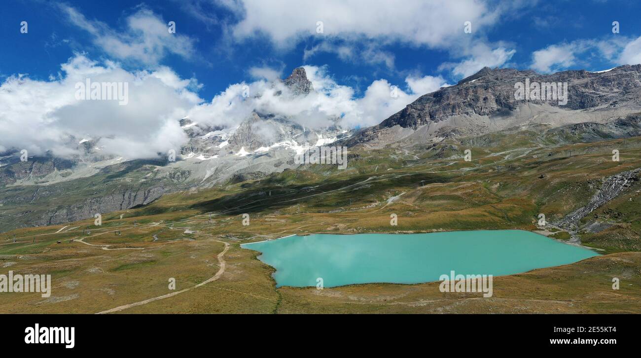 Aerial view of mount Cervino (Matterhorn) and Tramail de Vieille lake from the fields of Plan Maison, Aosta Valley, northern Italy. Stock Photo