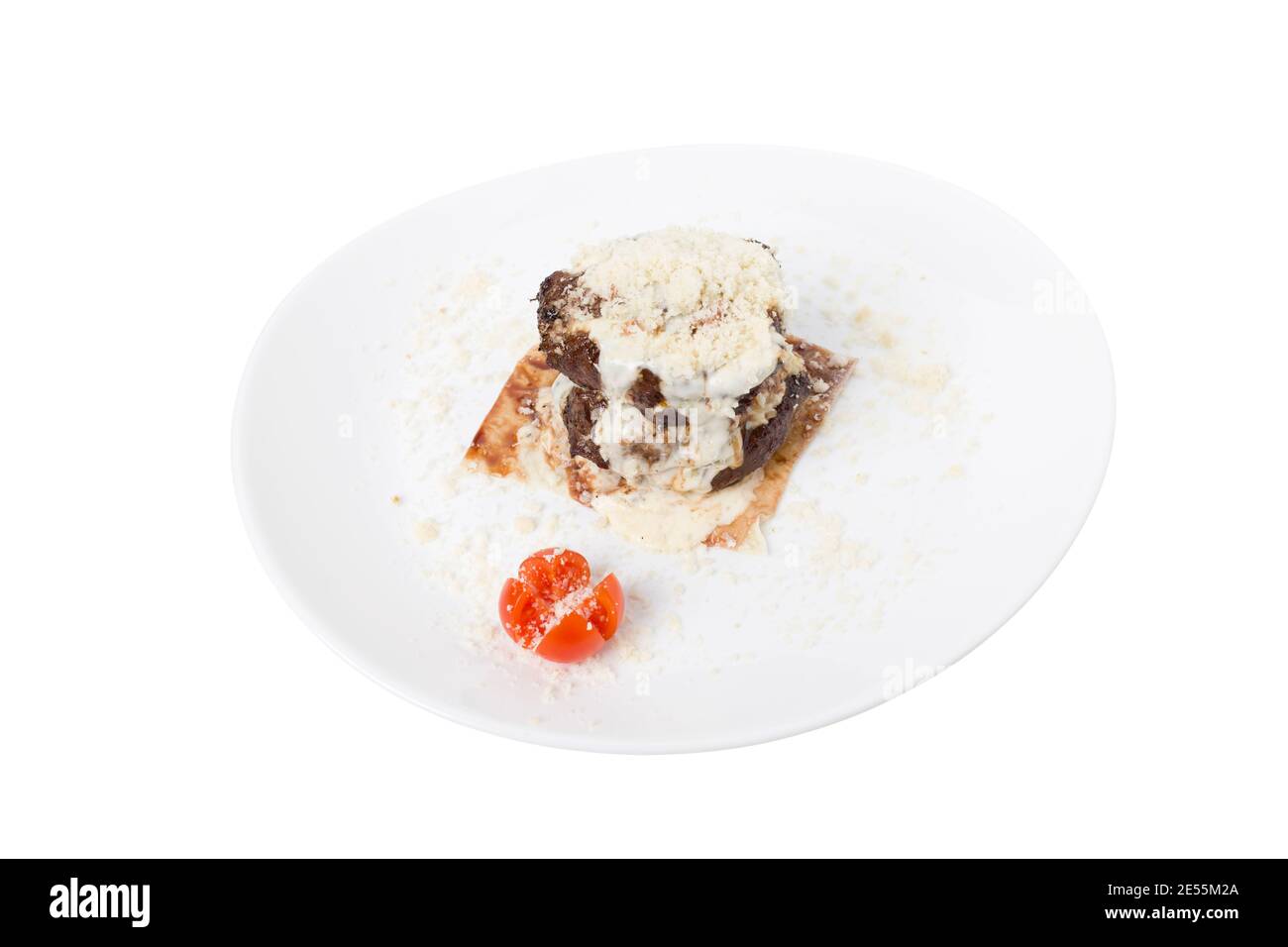 Meat medallion in white sauce on pita bread. This is isolated in a white background. Close-up. Stock Photo
