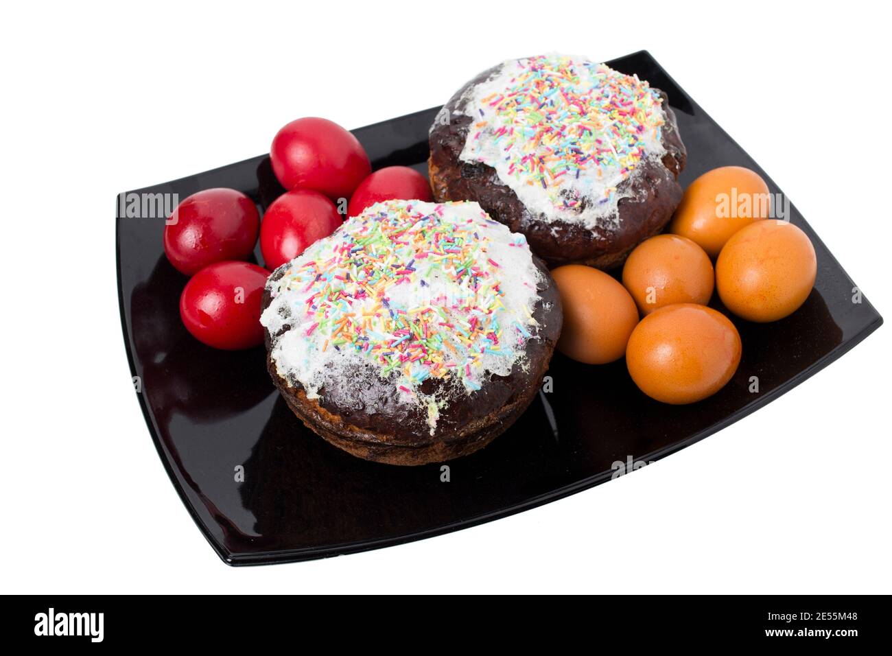 Colorful eggs with easter cake for the holiday. All this is isolated in a whiye background. Close-up. Stock Photo