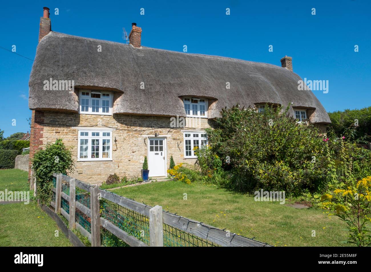 Pretty stone cottages with thatched roofs. Stock Photo