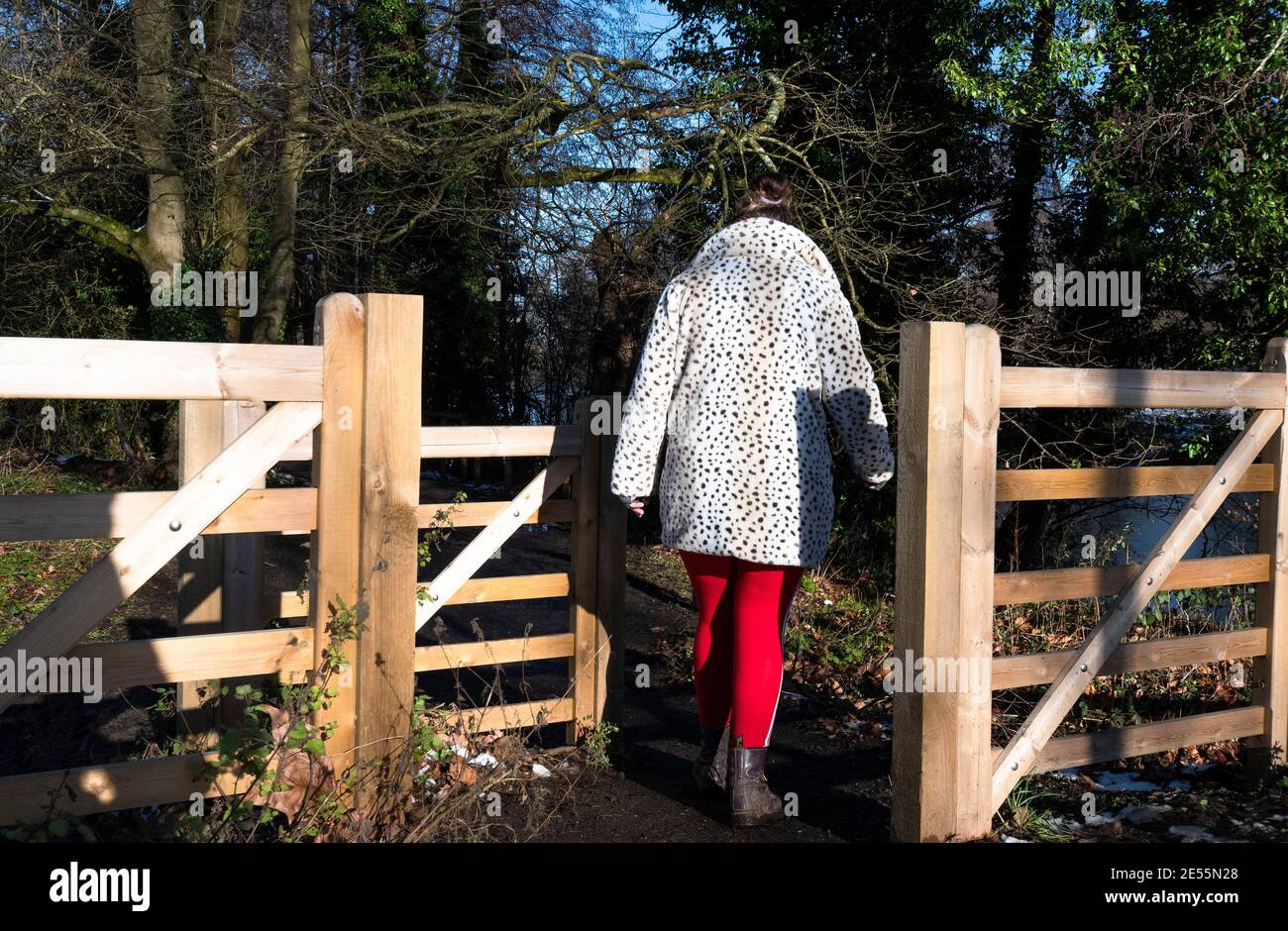 Woman in country park on a walk during lockdown in January 2021 - Reading, Berkshire, England, UK Stock Photo