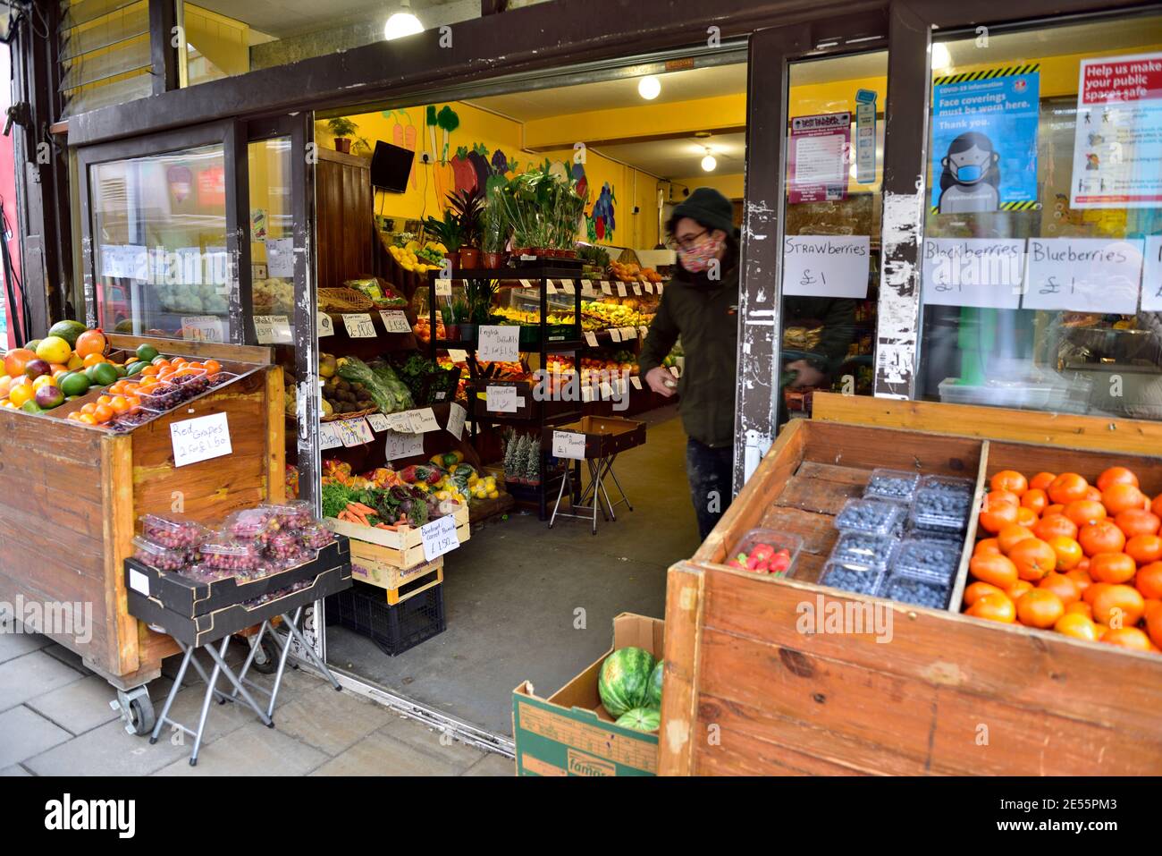Looking into local independent high street greengrocers and food corner store, UK Stock Photo