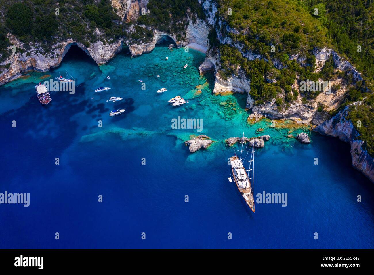 Aerial picture of a private sailing yacht in a secluded beach in Greece