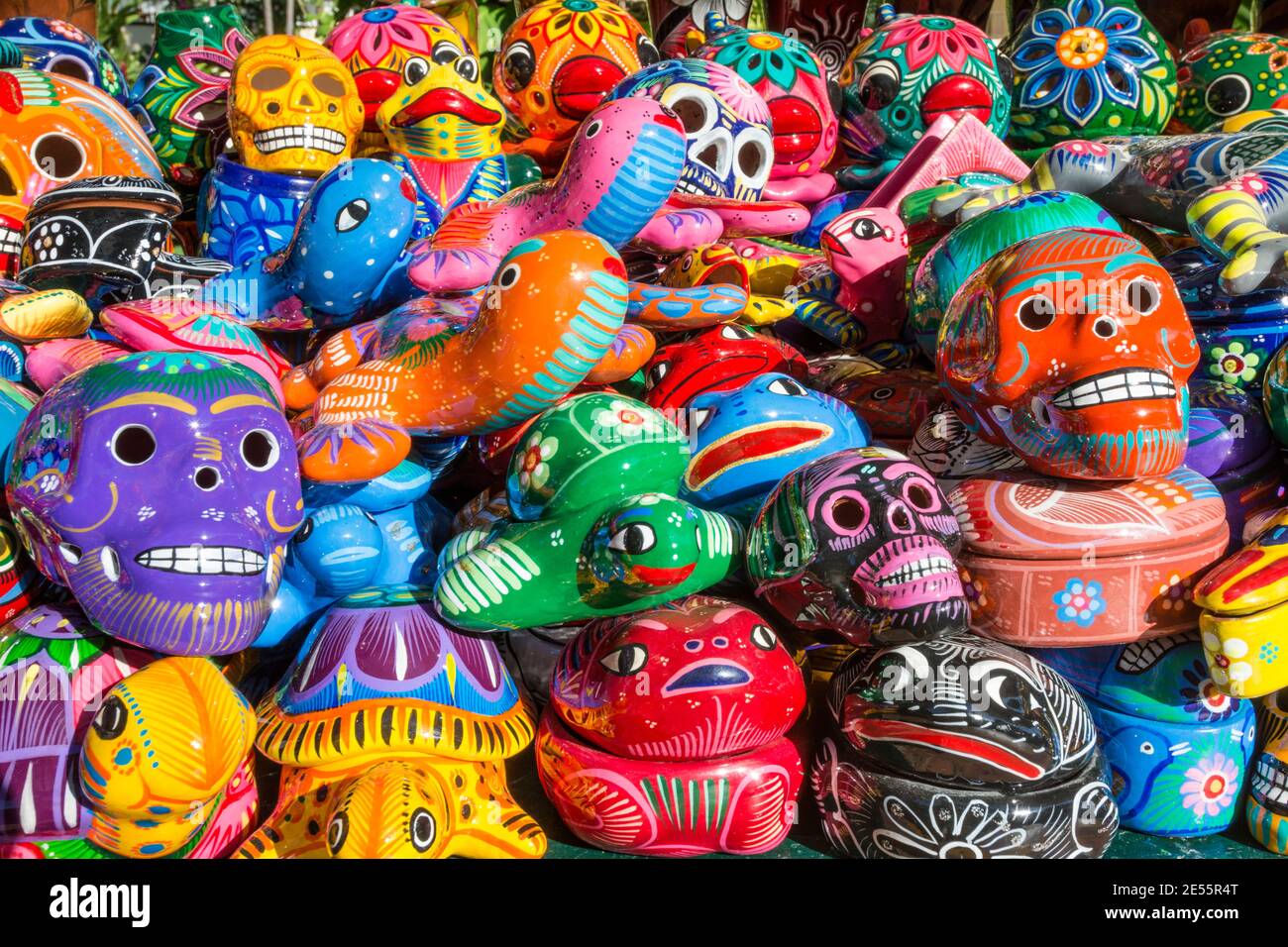 Colorful handpainted ceramic skull and animal figure souvenirs on sale