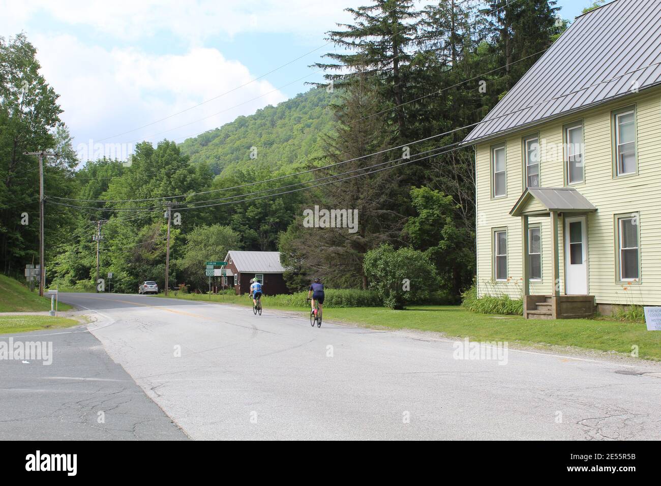Two cyclists in summer on the Vermont Route 100 Scenic Drive in ...