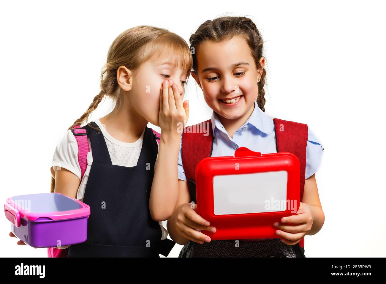 Pupils of primary school with lunch-boxes in hands. Girls with ...