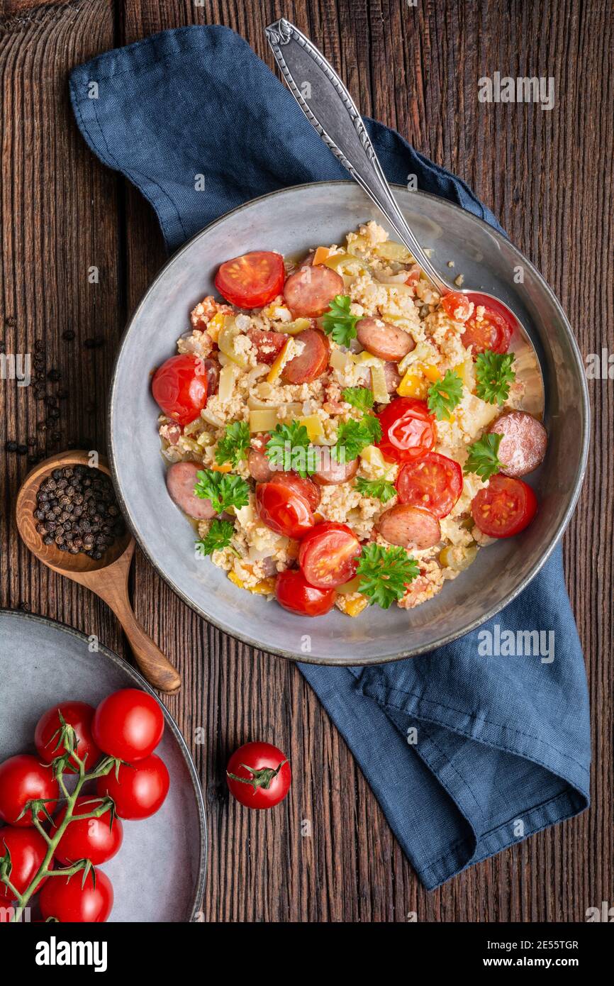 Leco, simple vegetable stew with tomatoes, bell pepper, onion, eggs and fried sausage slices Stock Photo