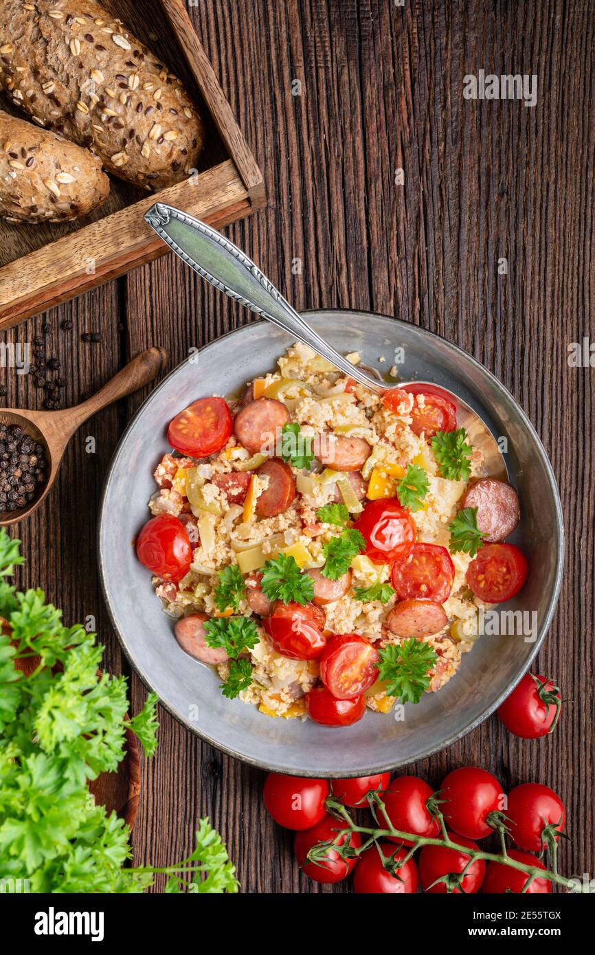 Leco, simple vegetable stew with tomatoes, bell pepper, onion, eggs and fried sausage slices Stock Photo
