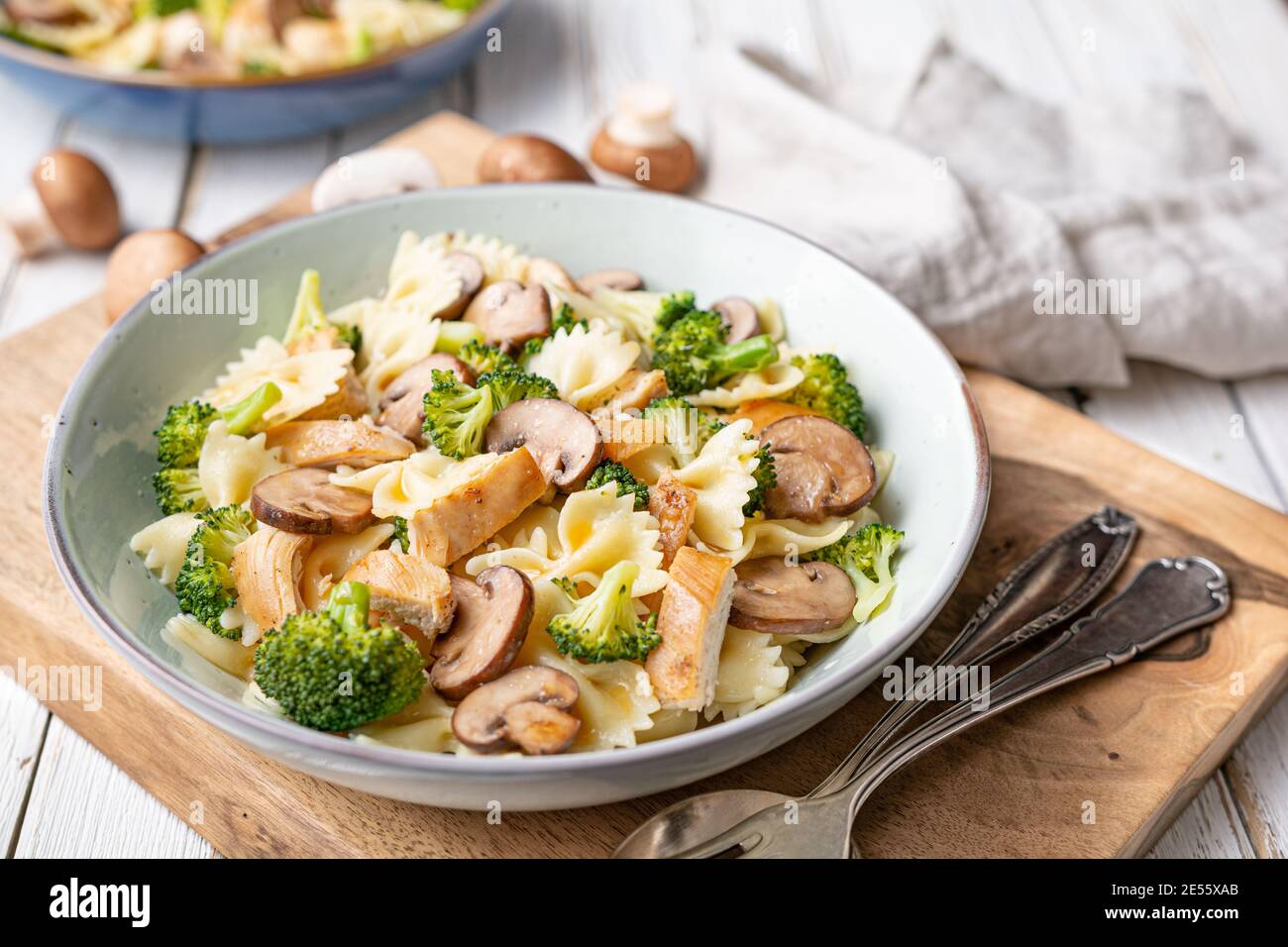 Mushroom pasta salad with steamed broccoli and baked chicken meat slices for lunch Stock Photo