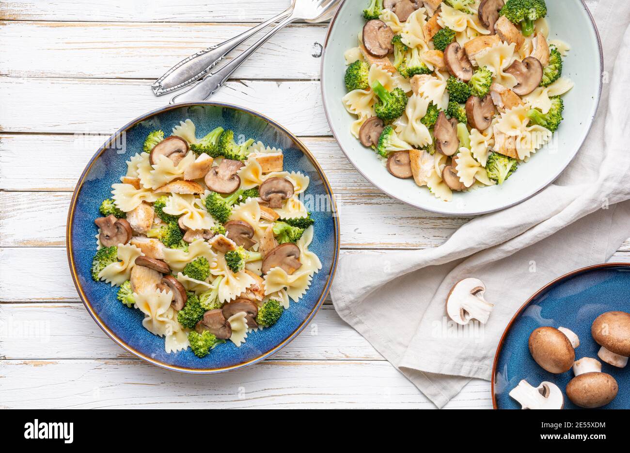 Mushroom pasta salad with steamed broccoli and baked chicken meat slices for lunch Stock Photo