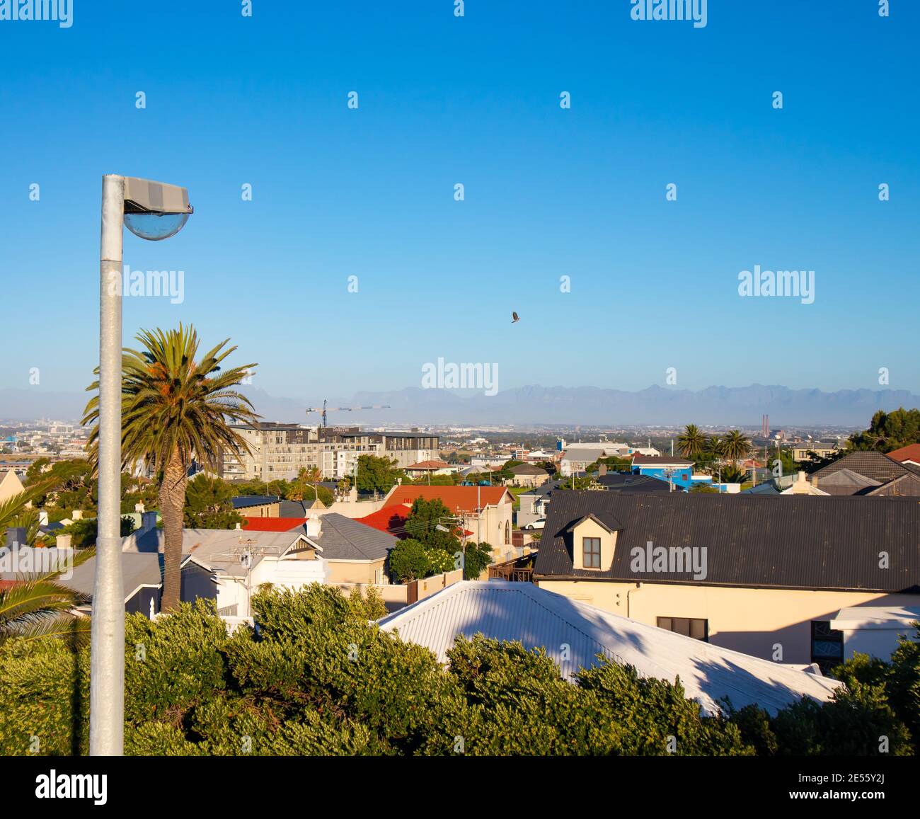 Nelson Mandela Boulevard- Cape Town, South Africa - 25-01-2021 Street lamp next to Nelson Mandela Boulevard on a warm afternoon. Sun setting over city Stock Photo