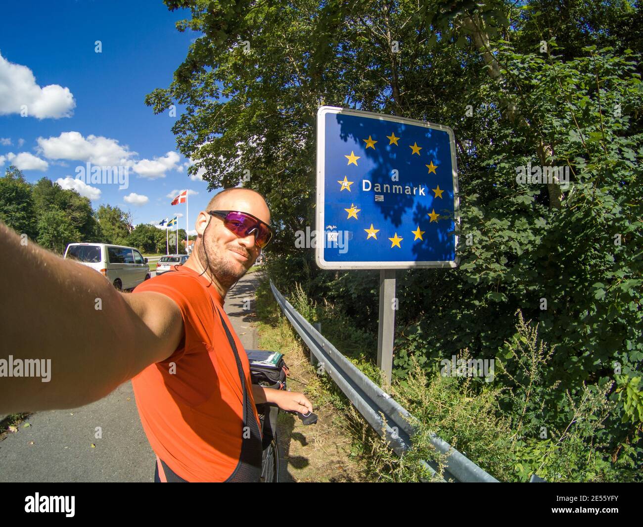 happy handsome attractive tourist on bicycle doing selfie in Flensburg
