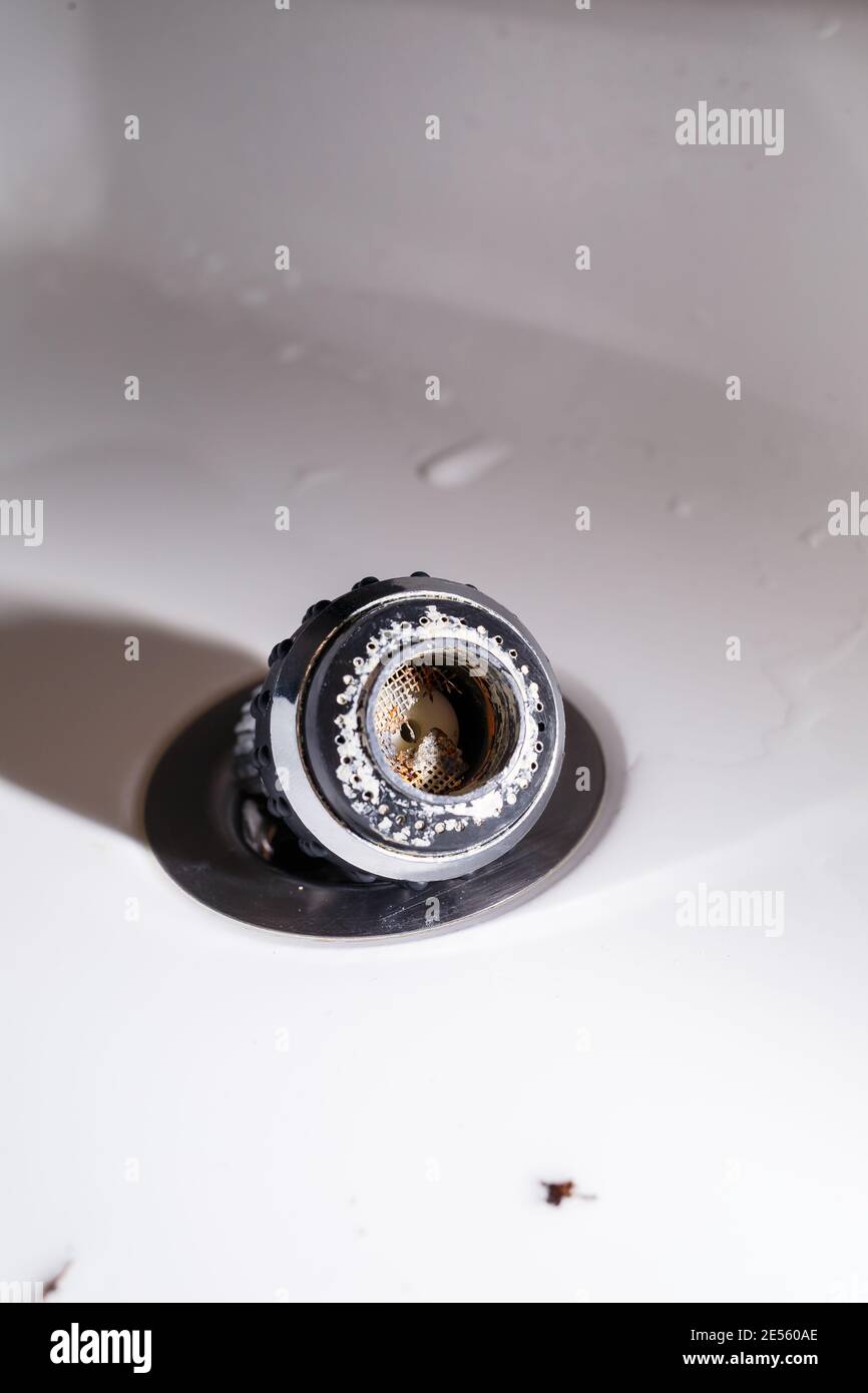 Old faucet aerator close-up on a white background. Broken sink mixer Stock Photo