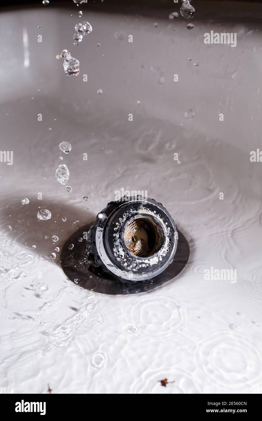 Old faucet aerator closeup on a white background. Broken sink mixer