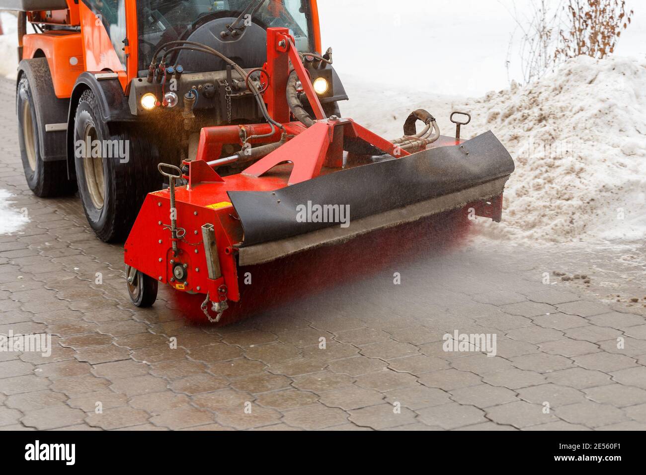 Snow cleaning process at winter city. Snow removal tractor clearing