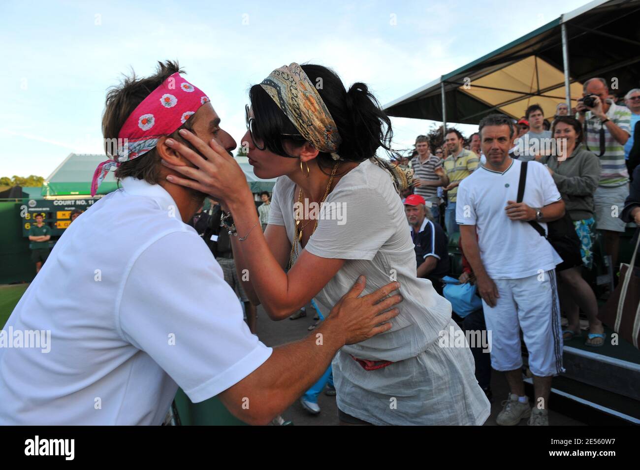 French singer Nolwenn Leroy kisses her boyfriend France's Arnaud Clement  after his victory against Crooatia's Marin Cilic in their fourth round of  the Wimbledon tennis championships in London, UK on June 30,