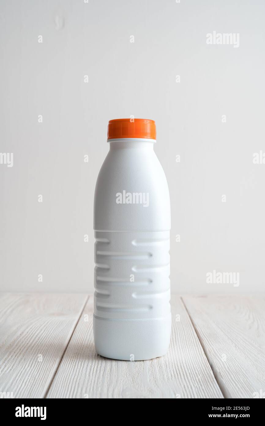 White plastic bottle on a light background. Side view with copy space. Stock Photo