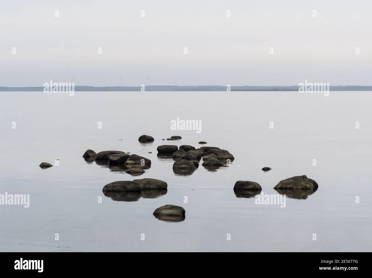 Scene with rocks in calm water in a bay of the Baltic Sea Stock Photo