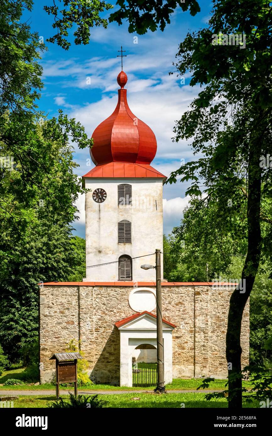 Vysoka, Czech Republic - July 6 2018: View of the preserved ruin of church of John the Baptist built in 13th century, white tower with clock. Stock Photo