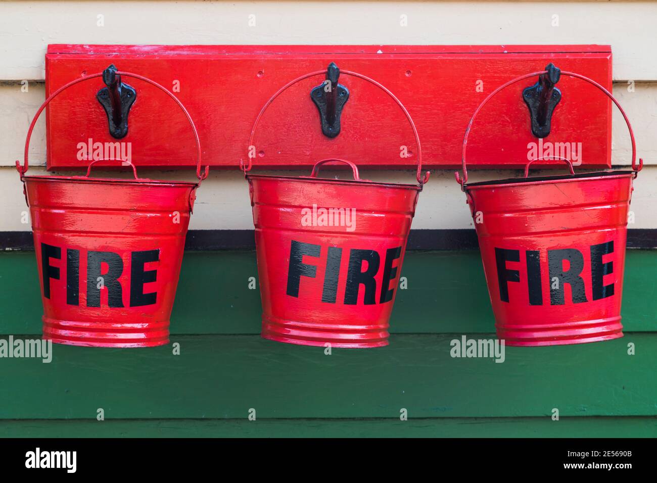 Close up of red fire buckets hanging on the platform. Stock Photo