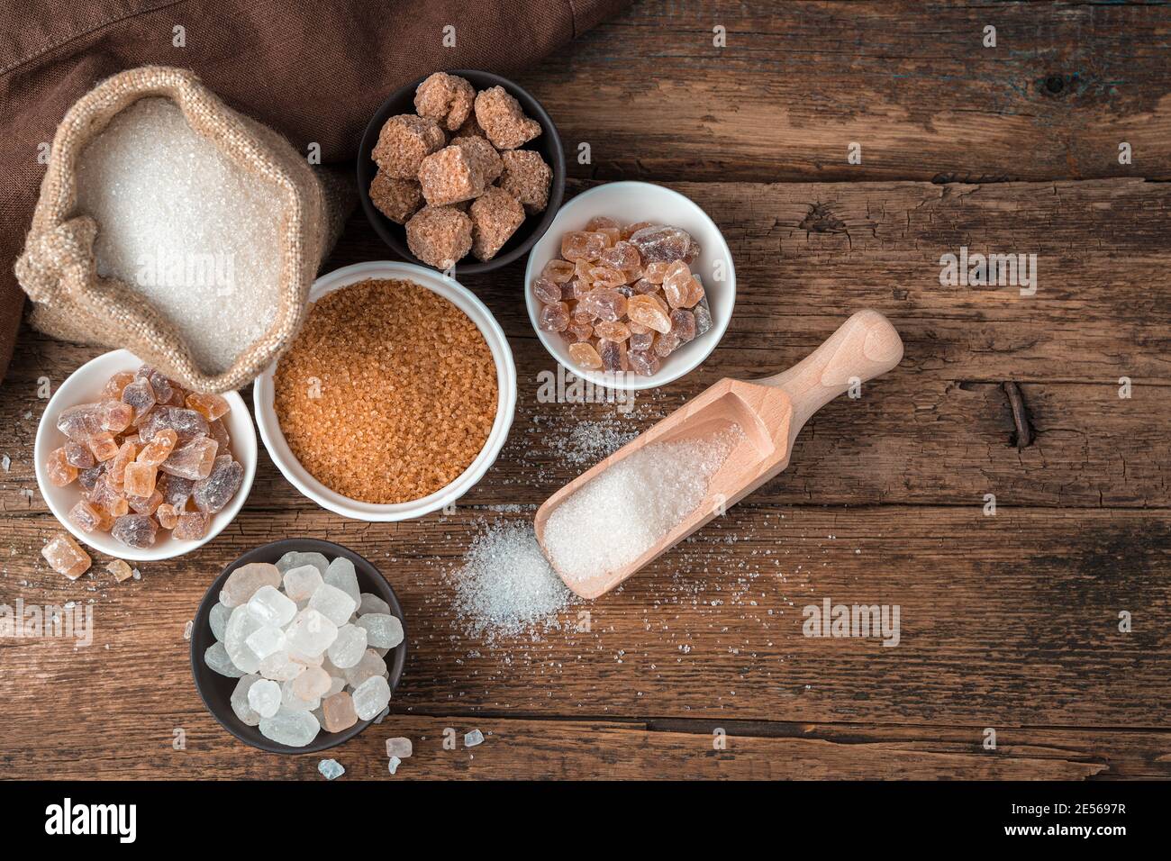 Many types of sugar on a wooden background. Top view with copy space. Stock Photo