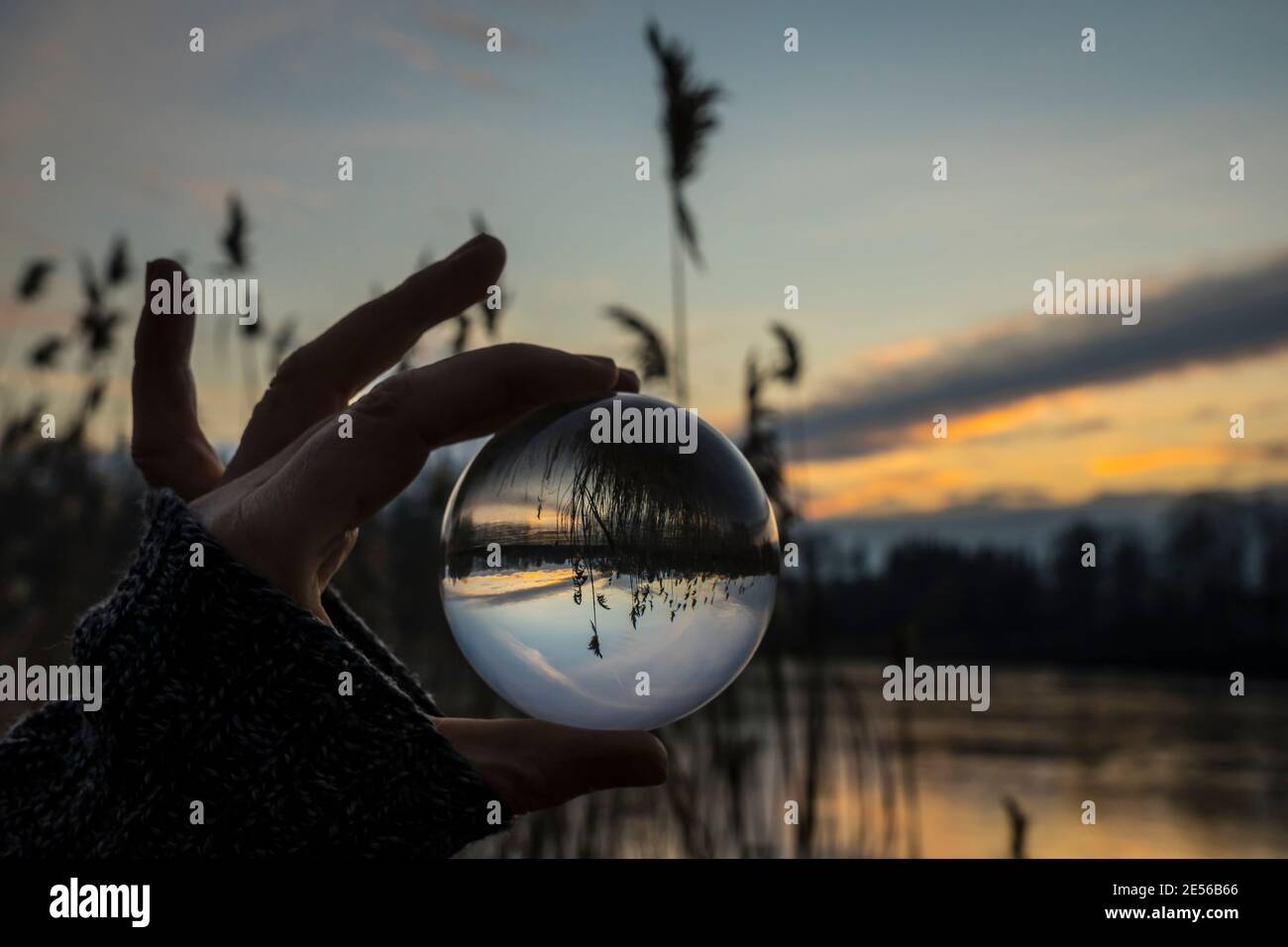 sunset on a icy winter evening seen in a lensball Stock Photo