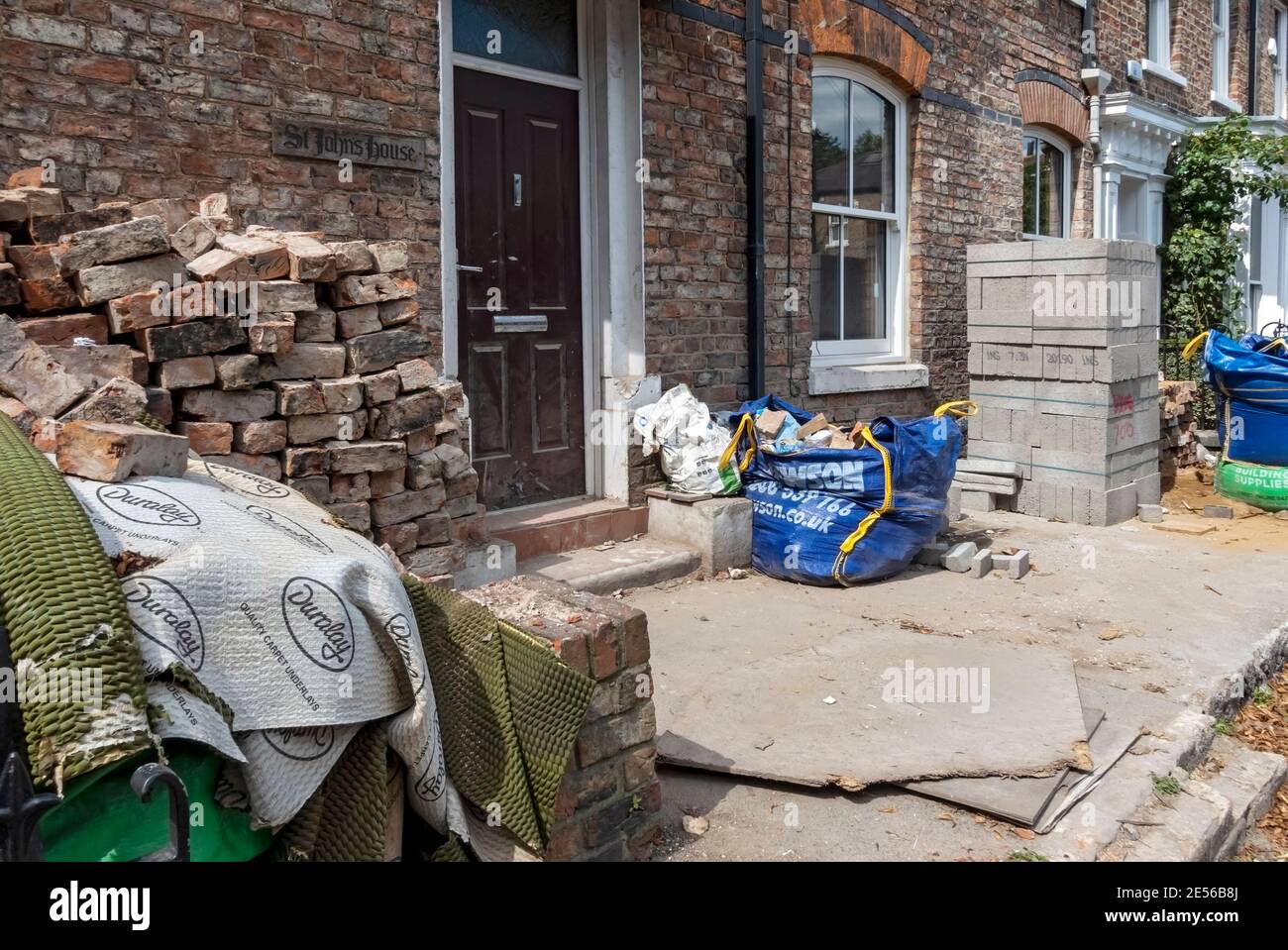 Bricks and building material outside a property during a house renovation. Stock Photo