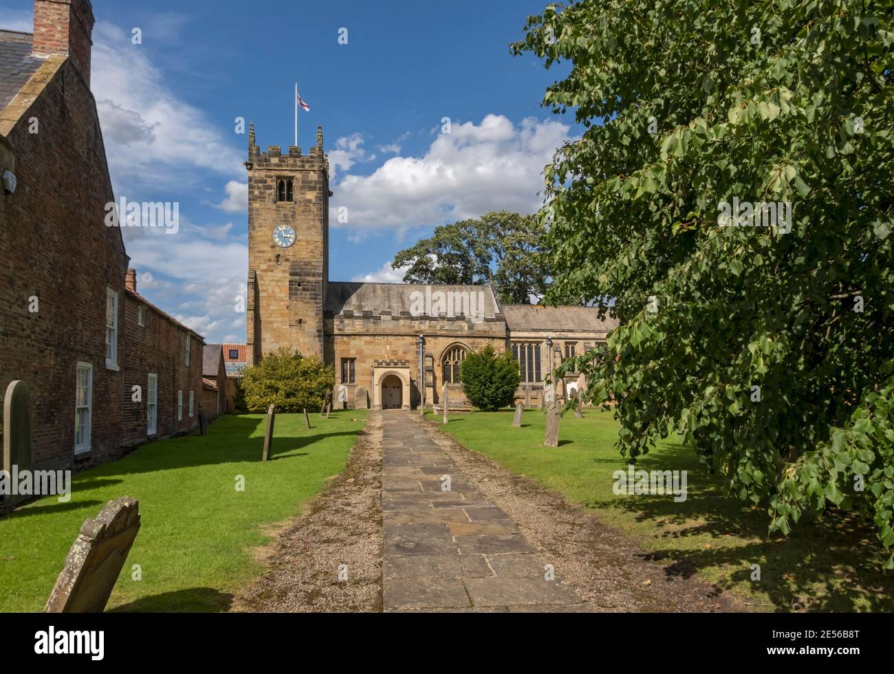 All Hallows Church and gravestones in summer Sutton on the Forest near York. Stock Photo