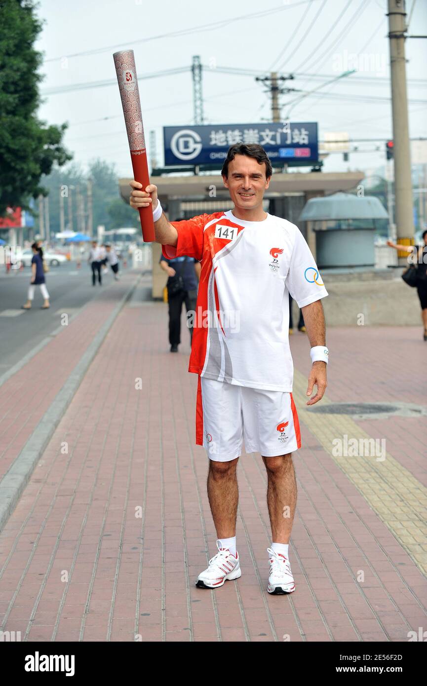 CEO of Carrefour China Eric Legros poses with the olympic flame